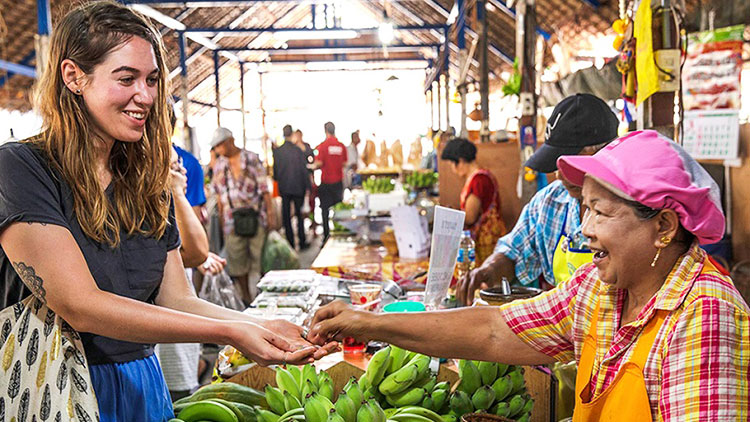 A tourist haggle with a local stall holder