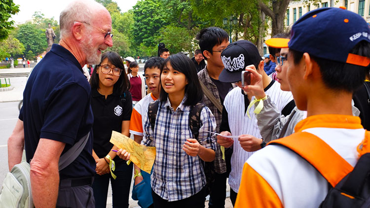 Vietnamese youths speaking English to foreigners